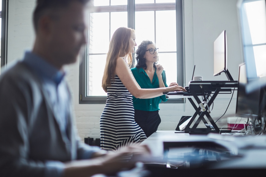 woman at standing desk proper ergonomics